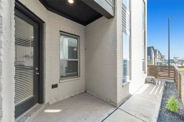 a view of a balcony a chair and floor to ceiling window