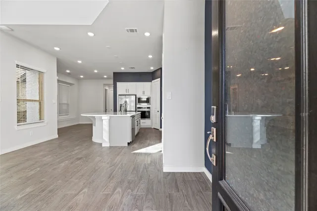 a view of a kitchen with a refrigerator and a window