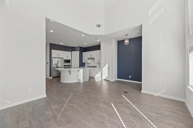 a view of a kitchen with refrigerator and an ocean view