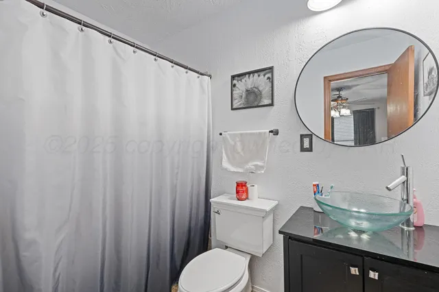 a white toilet sitting next to a bathroom sink