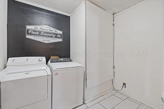 a view of storage and utility room with washer and dryer