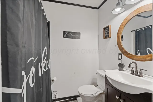 a bathroom with a sink toilet and a mirror