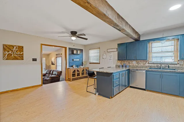 a kitchen with cabinets and window