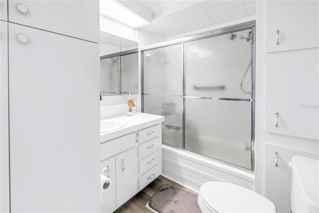1100 South Belcher Road, Unit 502 Largo, FL 33771 - Photo 22 of 51 a bathroom with a double vanity sink toilet mirror and shower