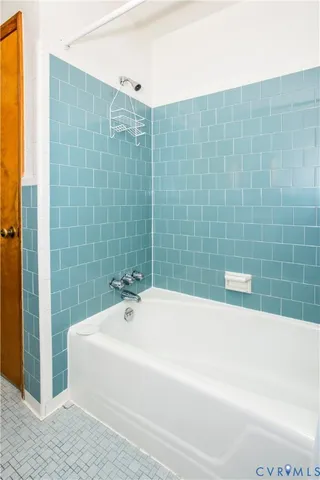 wooden floor in room with furniture and a ceiling fan