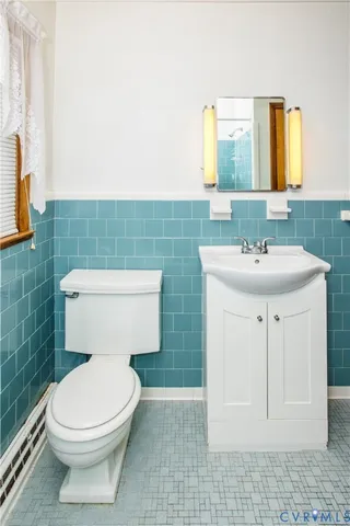 a spacious bedroom with a bed and a chandelier