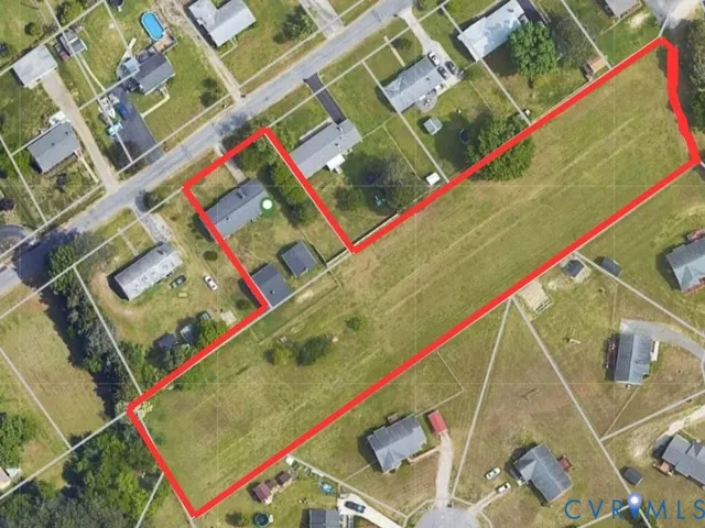 a kitchen with a refrigerator a stove top oven cabinetry and a large window