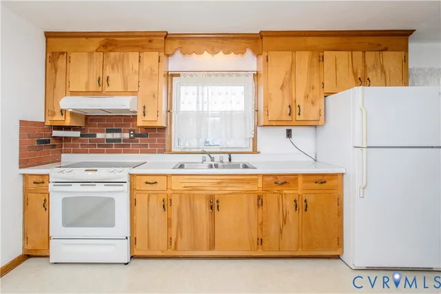 a kitchen with a stove a sink and a refrigerator
