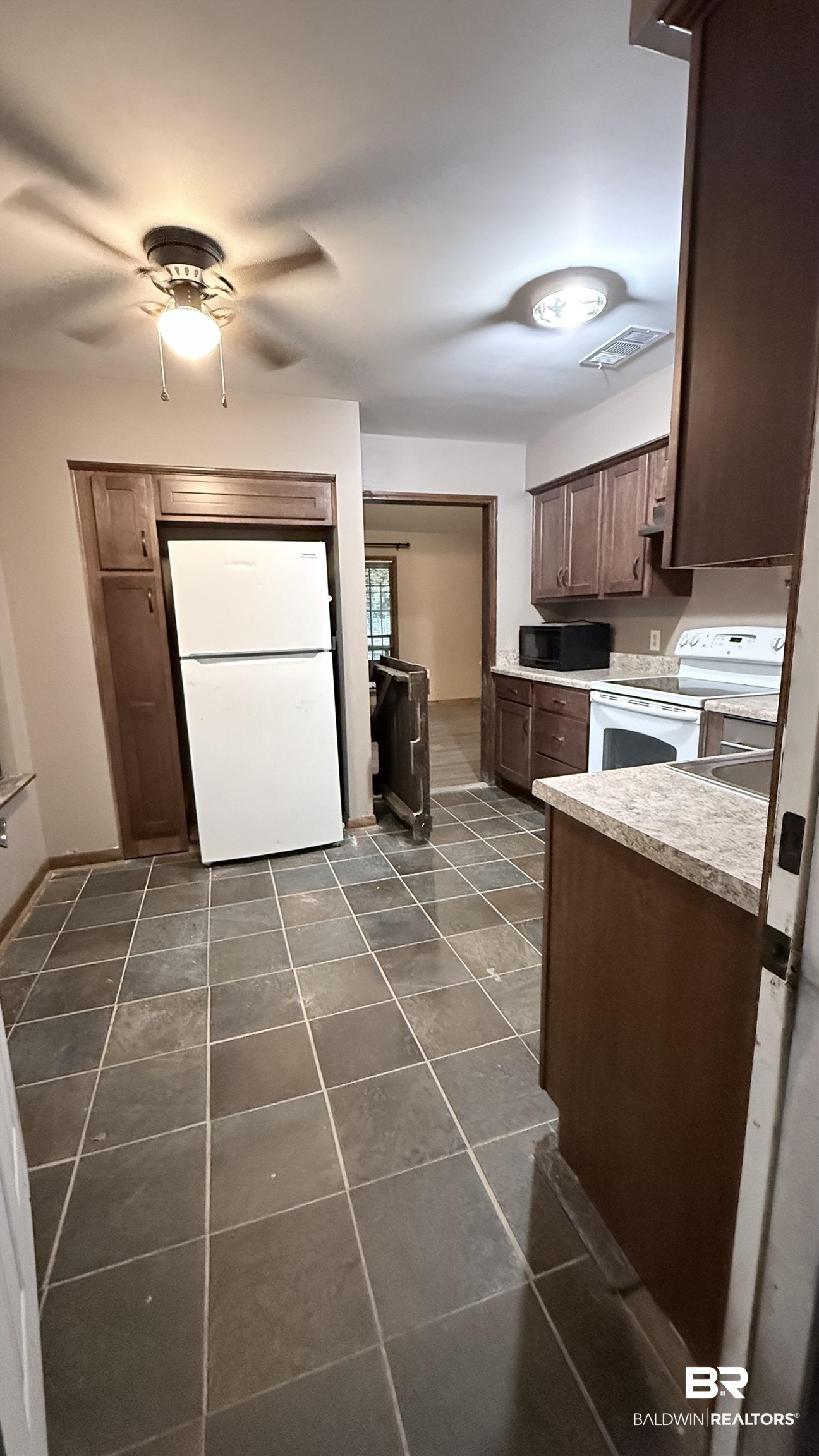 4131 Springdale Road Mobile, AL 36609 - Photo 11 of 28 Kitchen with light countertops, white appliances, dark brown cabinetry, and ceiling fan