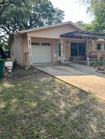 a view of a house with a yard and garage