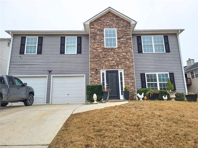 a front view of a house with a yard