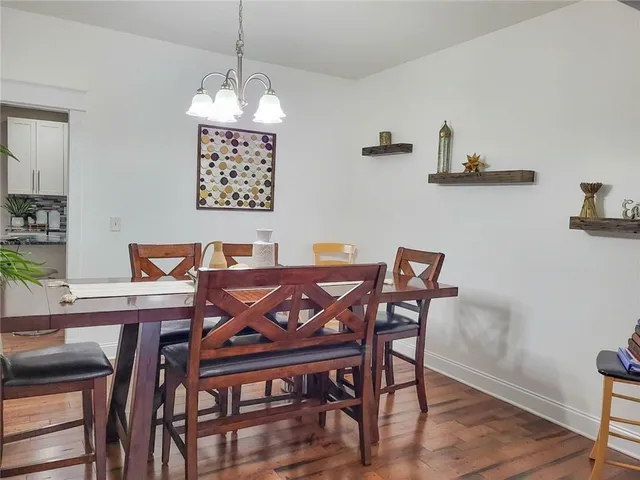 a view of a dining room with furniture wooden floor and a chandelier