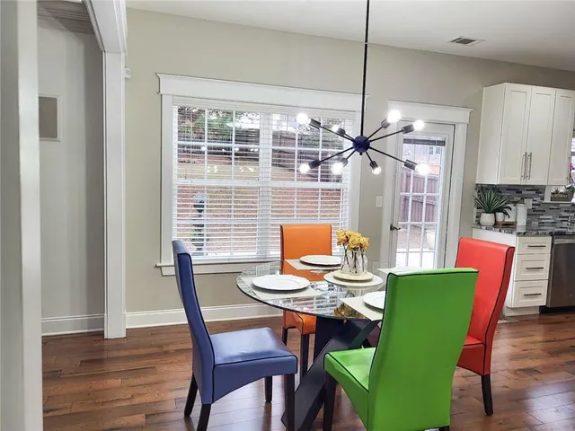 a view of a dining room with furniture window and wooden floor