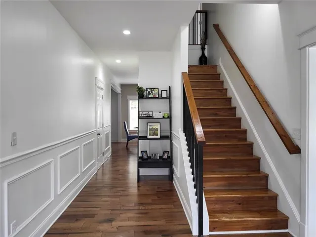 a view of entryway and hall with wooden floor