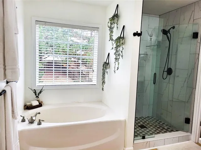 a bath tub sitting next to a shower