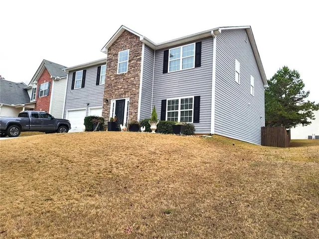 a front view of a house with a yard