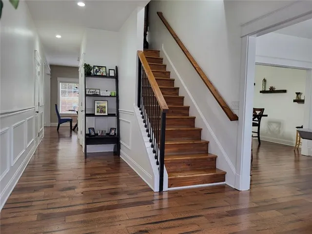 a view of entryway and hall with wooden floor