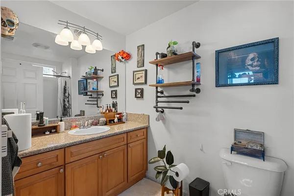 a bathroom with a sink mirror and toilet
