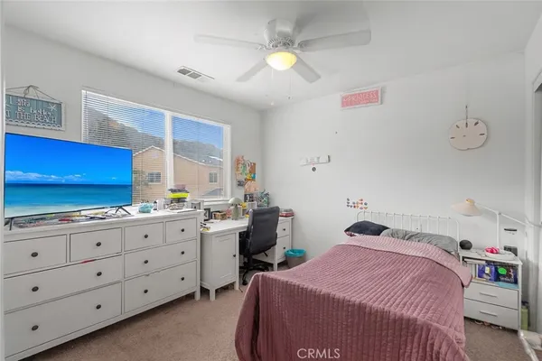 a bedroom with a bed and a dresser in it
