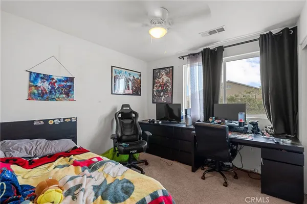 a bedroom that has a bed and a desk in it