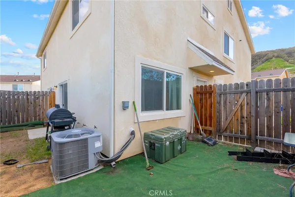 a view of a backyard with chairs and a grill