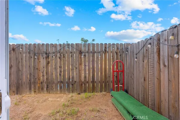 a view of a backyard with wooden fence
