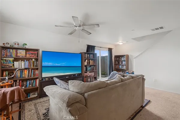 a living room with furniture and a book shelf