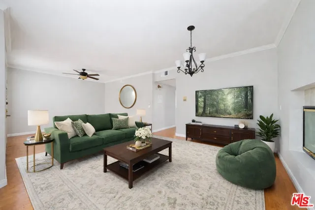 a living room with furniture a rug and a flat screen tv