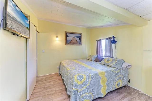 a bed sitting in a bedroom next to a bathroom