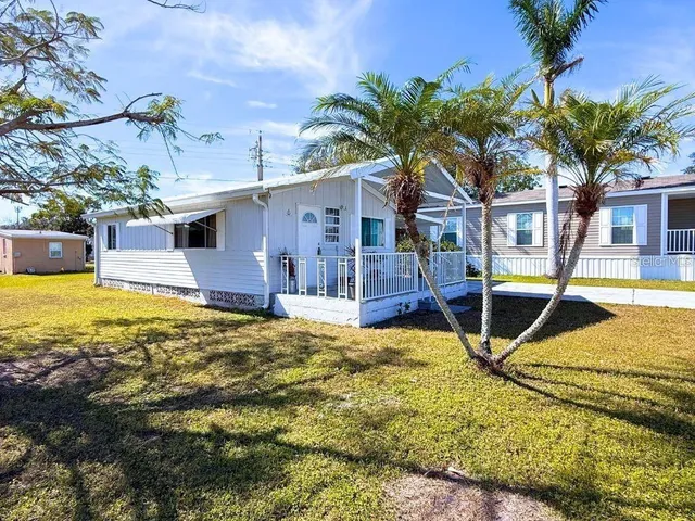 a view of a house with backyard and swimming pool