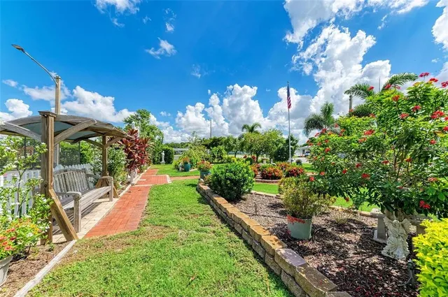 a view of yard with flower pots