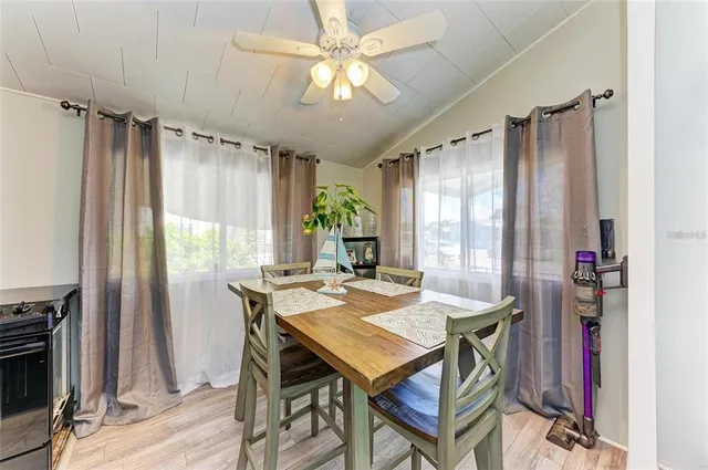 a view of a dining room with furniture window and wooden floor