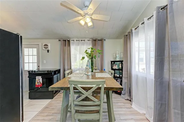a view of a dining room with furniture window and wooden floor