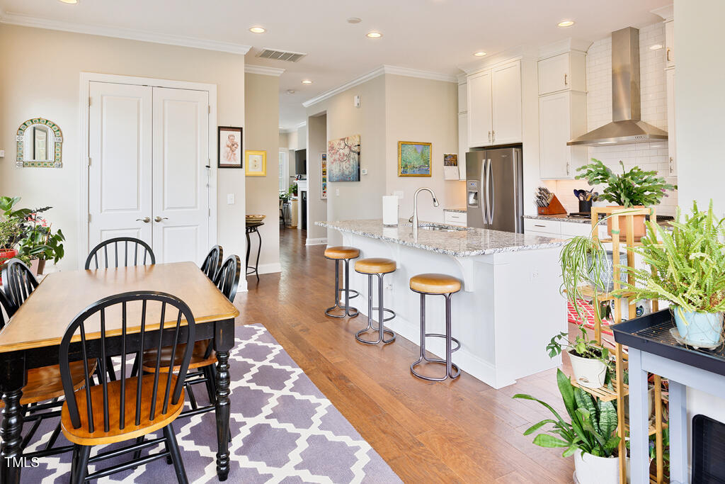 910 Wake Towne Drive Raleigh, NC 27609 - Photo 12 of 45 a view of a dining room kitchen with furniture and a potted plant