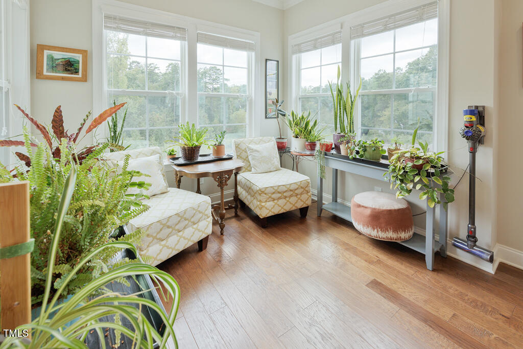 910 Wake Towne Drive Raleigh, NC 27609 - Photo 14 of 45 a living room with patio furniture and a potted plant
