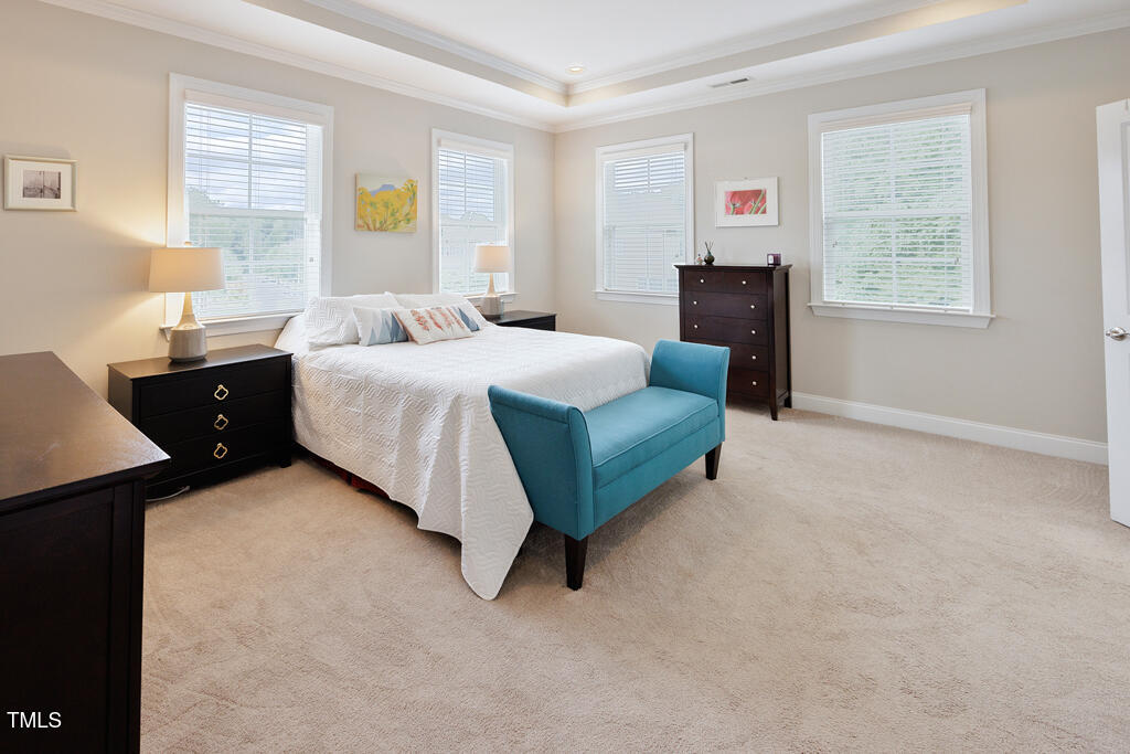 910 Wake Towne Drive Raleigh, NC 27609 - Photo 19 of 45 a spacious bedroom with a bed and window