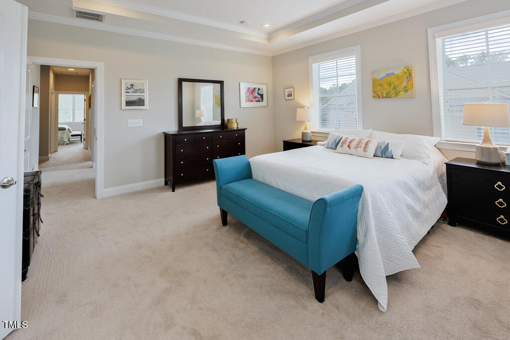 910 Wake Towne Drive Raleigh, NC 27609 - Photo 20 of 45 a bedroom with a bed and dresser