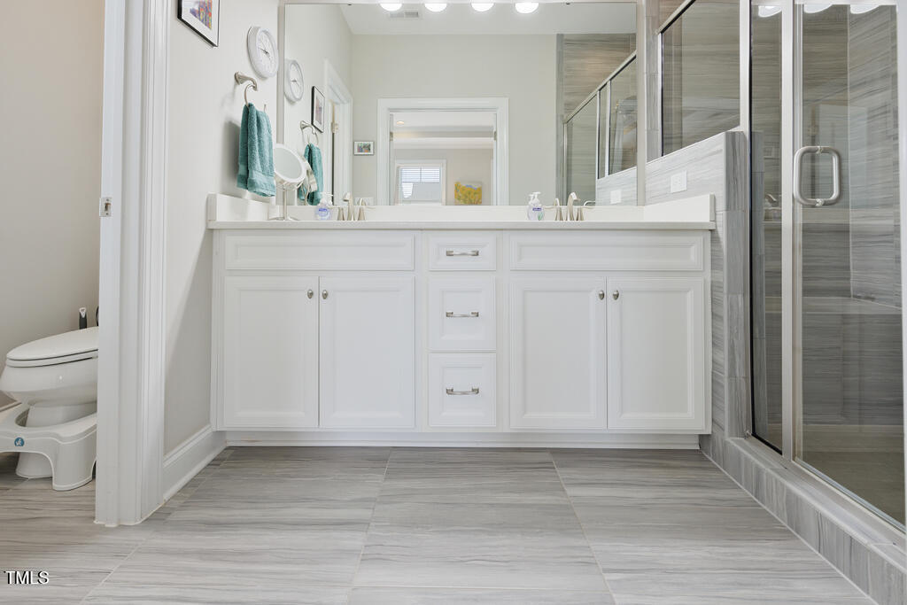 910 Wake Towne Drive Raleigh, NC 27609 - Photo 23 of 45 a bathroom with a sink and a mirror