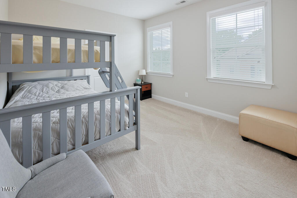 910 Wake Towne Drive Raleigh, NC 27609 - Photo 27 of 45 a bedroom with furniture and a window