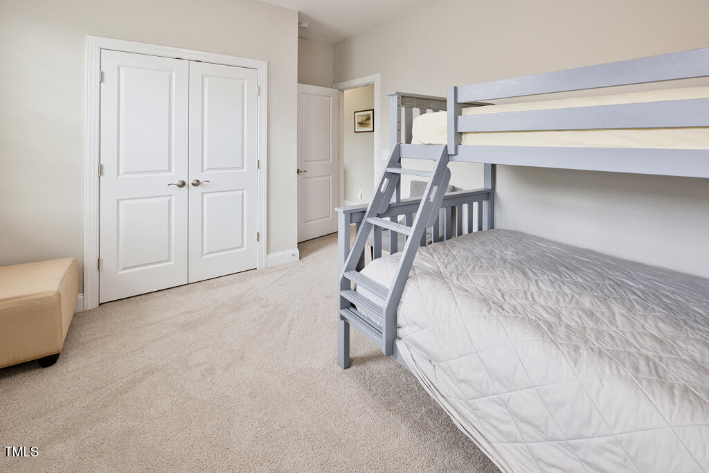 910 Wake Towne Drive Raleigh, NC 27609 - Photo 28 of 45 a bedroom with a bed and a chair