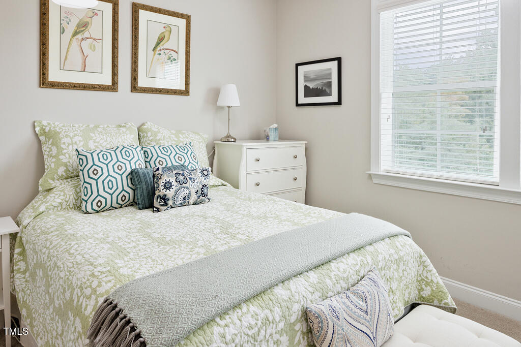 910 Wake Towne Drive Raleigh, NC 27609 - Photo 30 of 45 a large bed sitting in a bedroom next to a window