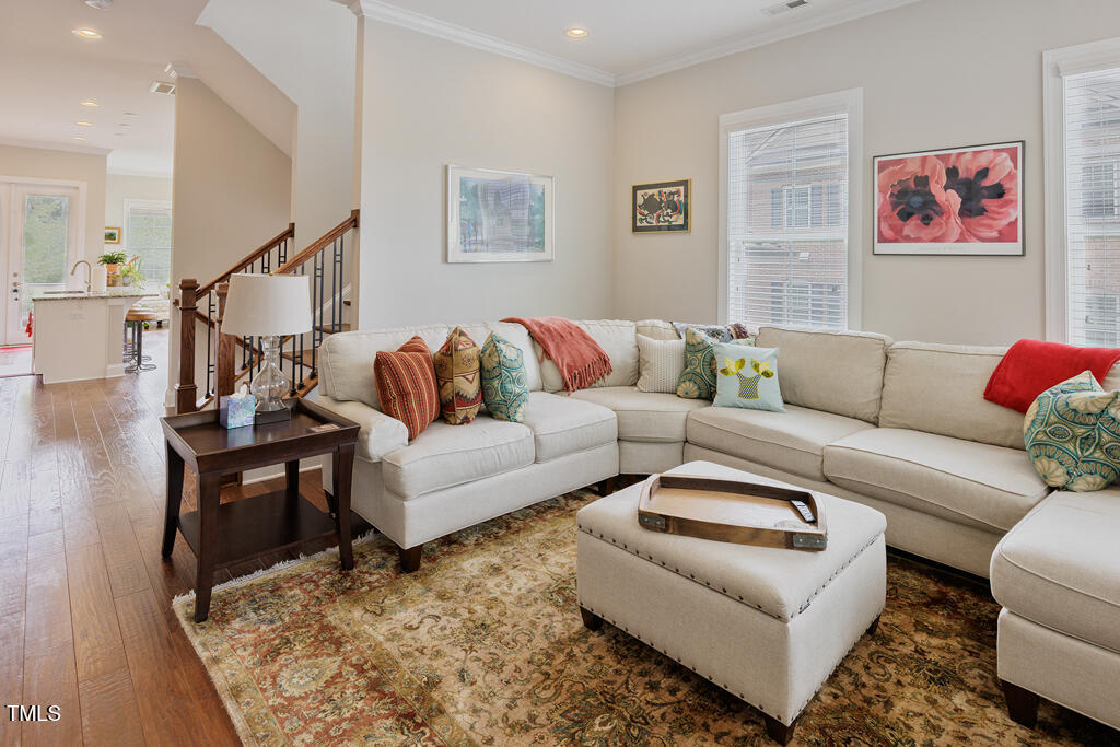 910 Wake Towne Drive Raleigh, NC 27609 - Photo 3 of 45 a living room with furniture and a rug
