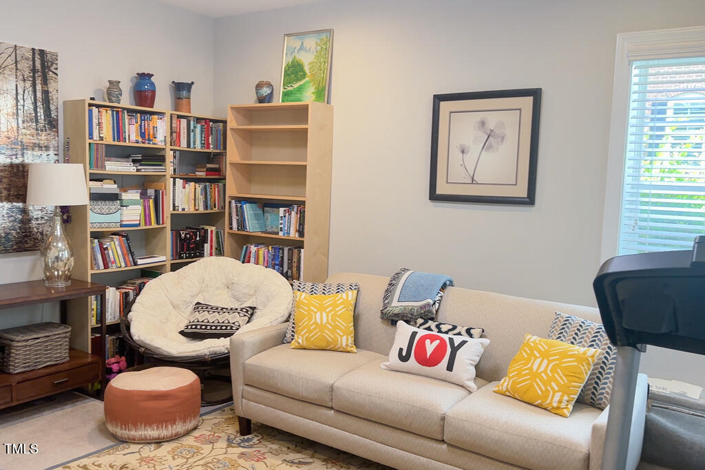 910 Wake Towne Drive Raleigh, NC 27609 - Photo 32 of 45 a living room with furniture and a book shelf