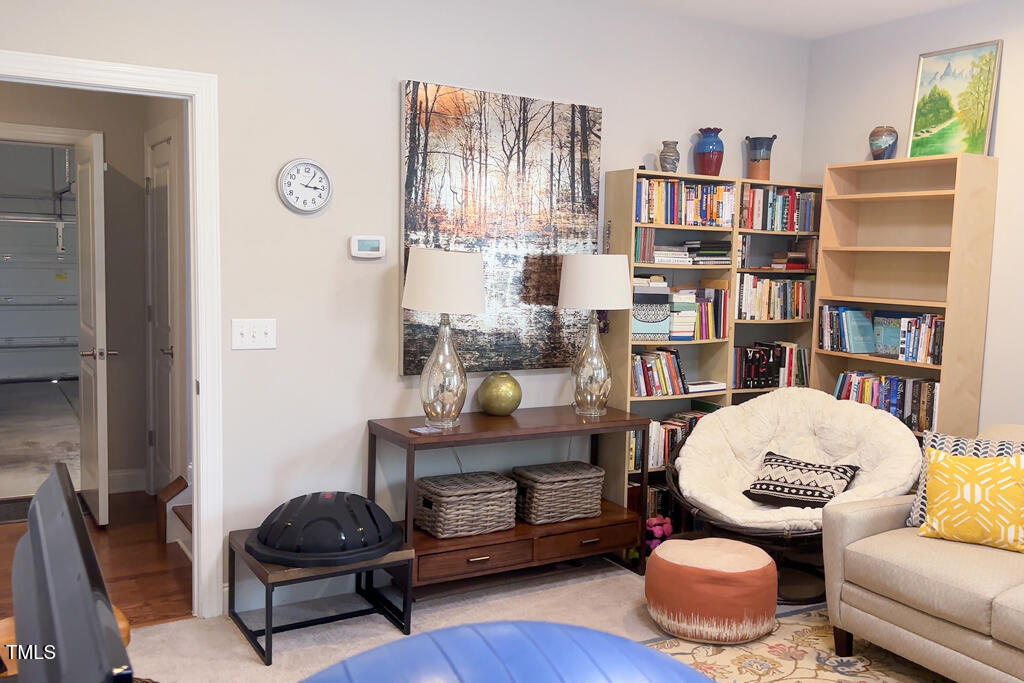 910 Wake Towne Drive Raleigh, NC 27609 - Photo 33 of 45 a living room with furniture and a book shelf