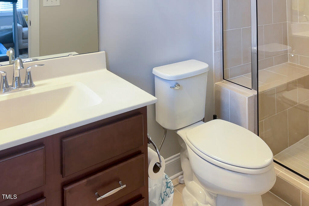 910 Wake Towne Drive Raleigh, NC 27609 - Photo 34 of 45 a white toilet sitting next to a bathroom sink