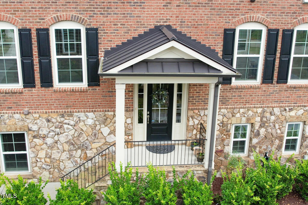 910 Wake Towne Drive Raleigh, NC 27609 - Photo 36 of 45 front view of a brick house with large windows