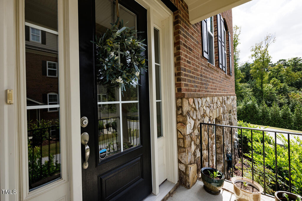 910 Wake Towne Drive Raleigh, NC 27609 - Photo 38 of 45 a view of a balcony with table and chairs and potted plants