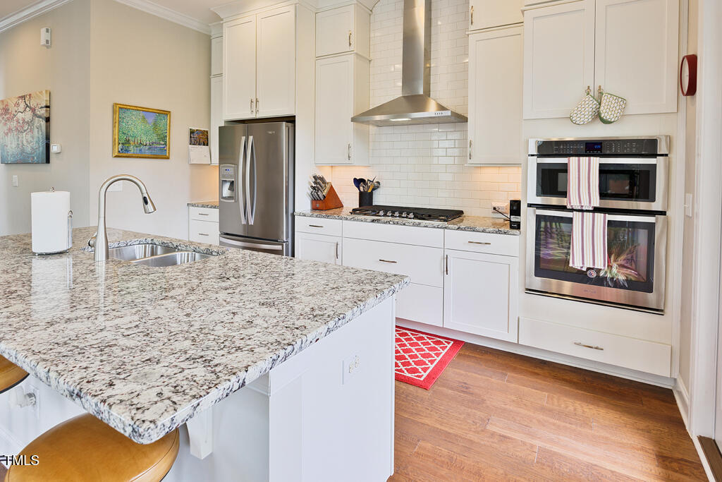 910 Wake Towne Drive Raleigh, NC 27609 - Photo 6 of 45 a kitchen with stainless steel appliances granite countertop a sink stove and refrigerator