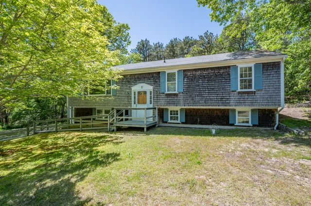 a view of a house with backyard porch and sitting area