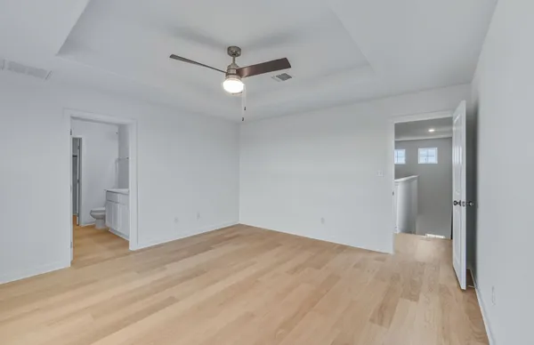 a bathroom with a toilet a sink a mirror and a shower